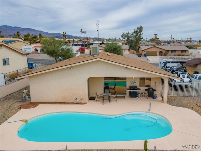89 Keywester Dr, Lake Havasu, AZ 86403 - view of pool featuring grilling area, a fenced in pool, a fenced backyard, a mountain view, and a patio