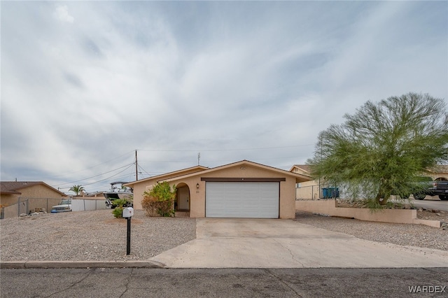 89 Keywester Dr, Lake Havasu, AZ 86403 - view of front of property with an attached garage, fence, driveway, and stucco siding