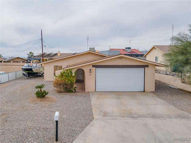 89 Keywester Dr, Lake Havasu, AZ 86403 - single story home featuring stucco siding, a garage, driveway, and fence