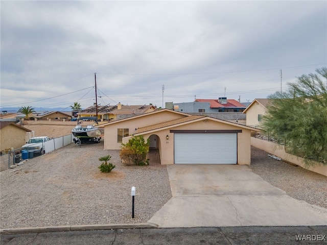 89 Keywester Dr, Lake Havasu, AZ 86403 - ranch-style home with stucco siding, concrete driveway, a garage, and fence