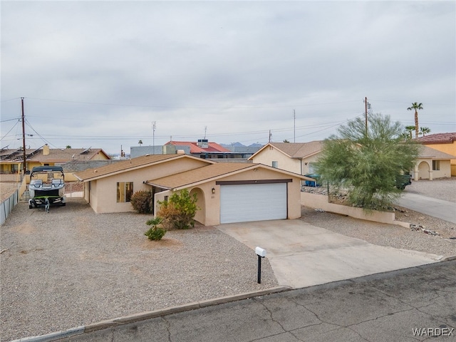 89 Keywester Dr, Lake Havasu, AZ 86403 - view of front of home featuring stucco siding, driveway, an attached garage, and fence