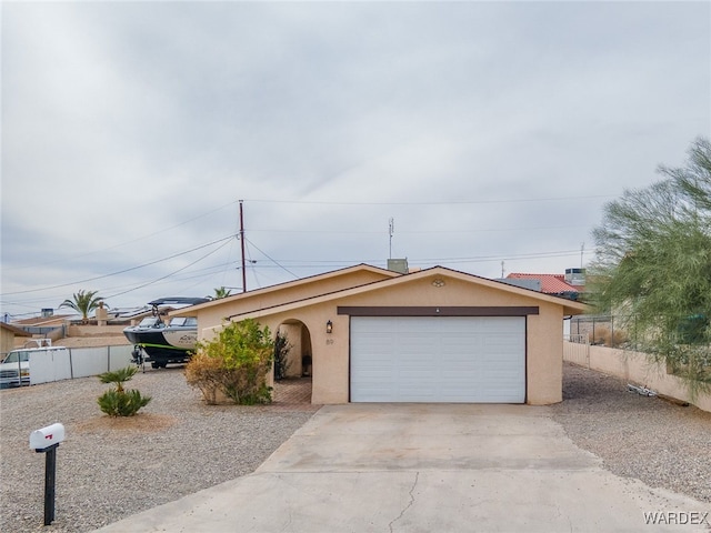 89 Keywester Dr, Lake Havasu, AZ 86403 - view of front of property with concrete driveway, fence, a garage, and stucco siding