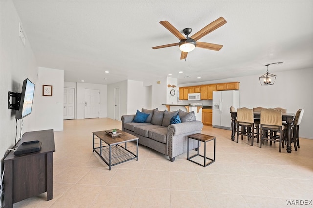 89 Keywester Dr, Lake Havasu, AZ 86403 - living area featuring light tile patterned floors, visible vents, recessed lighting, and ceiling fan with notable chandelier