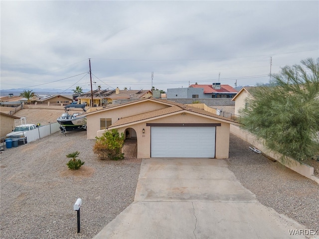 89 Keywester Dr, Lake Havasu, AZ 86403 - ranch-style house with stucco siding, concrete driveway, a garage, and fence