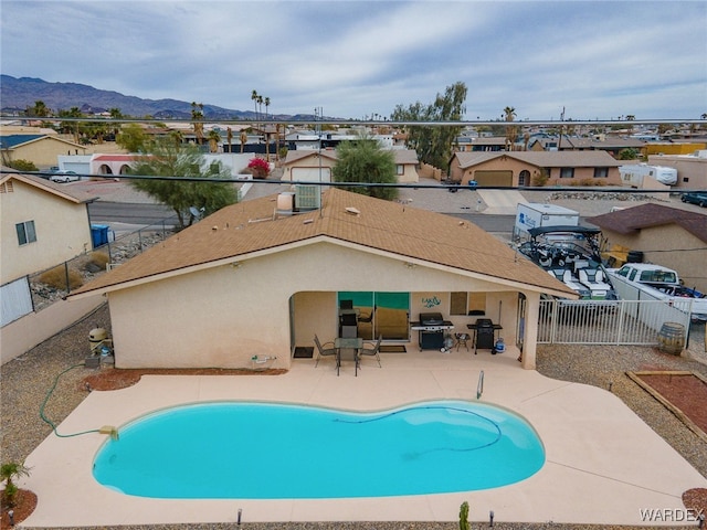 89 Keywester Dr, Lake Havasu, AZ 86403 - pool with grilling area, a residential view, a fenced backyard, a mountain view, and a patio
