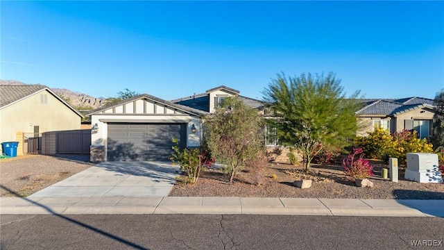 view of front facade featuring a garage, driveway, and a mountain view