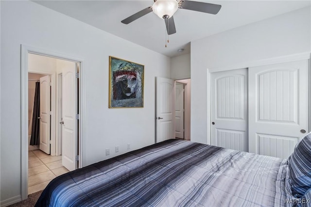 bedroom featuring light tile patterned floors, ceiling fan, and a closet