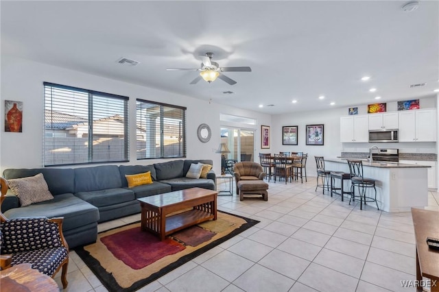 living room with recessed lighting, visible vents, ceiling fan, and light tile patterned flooring