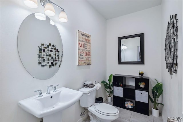 bathroom with tile patterned flooring, a sink, and toilet