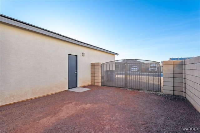 view of patio / terrace featuring fence and a gate