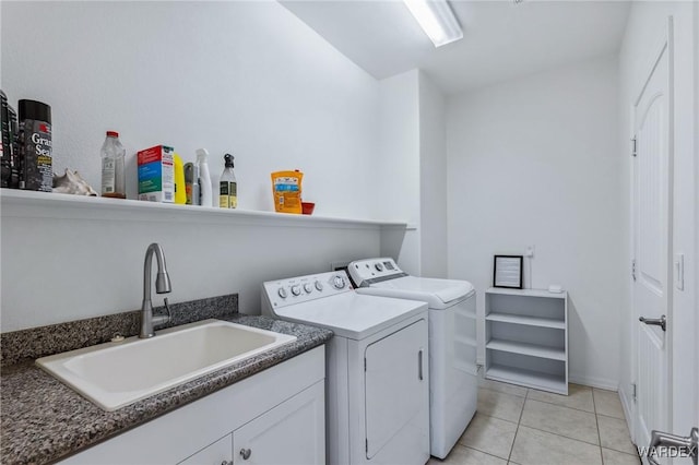 clothes washing area featuring a sink, washer and clothes dryer, and light tile patterned floors