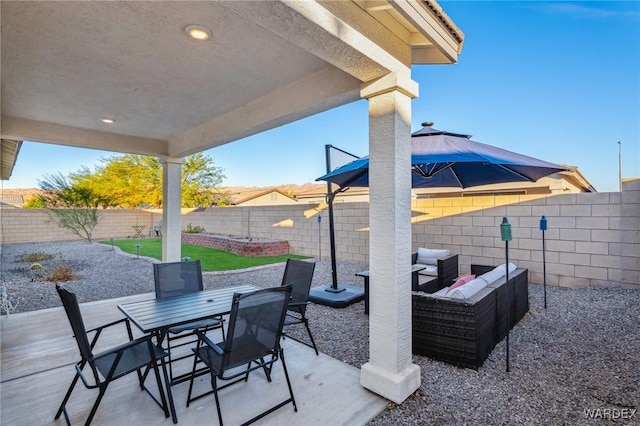 view of patio featuring a fenced backyard, an outdoor hangout area, and outdoor dining space