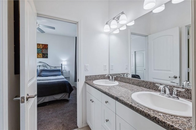 full bathroom featuring double vanity, ensuite bath, ceiling fan, and a sink