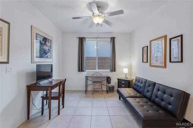 living room with ceiling fan, baseboards, and light tile patterned floors