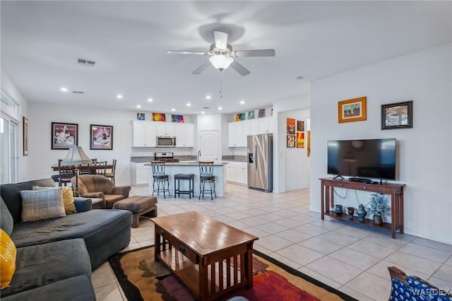 living area featuring recessed lighting, visible vents, a ceiling fan, and light tile patterned flooring