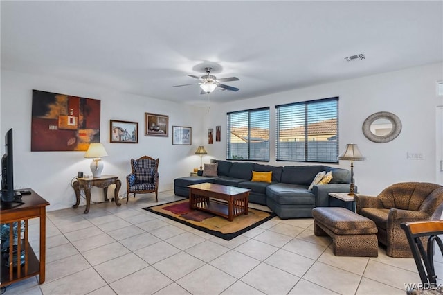 living area with light tile patterned flooring, visible vents, and a ceiling fan