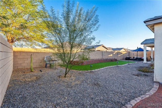 view of yard featuring a patio area and a fenced backyard