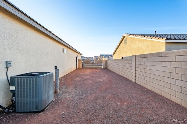 view of yard featuring central AC unit and a fenced backyard