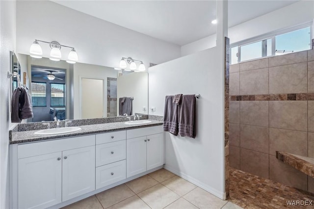 bathroom featuring ensuite bathroom, a sink, and a healthy amount of sunlight