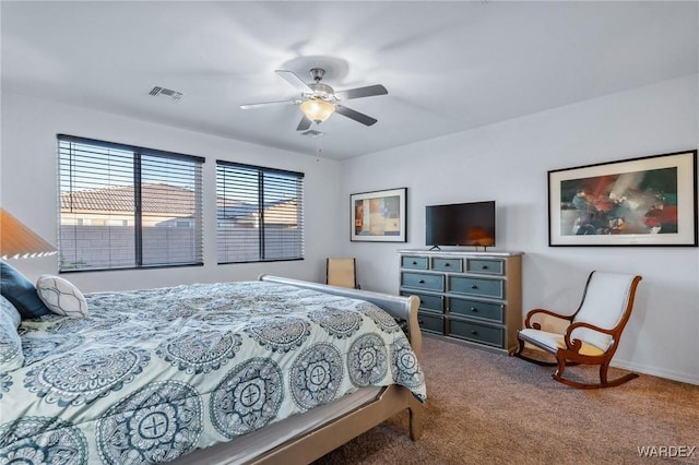 carpeted bedroom featuring visible vents and a ceiling fan