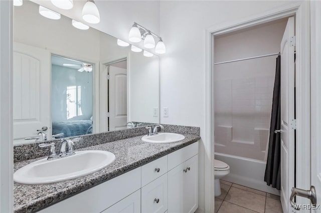 bathroom with toilet, shower / bath combo, a sink, and tile patterned floors