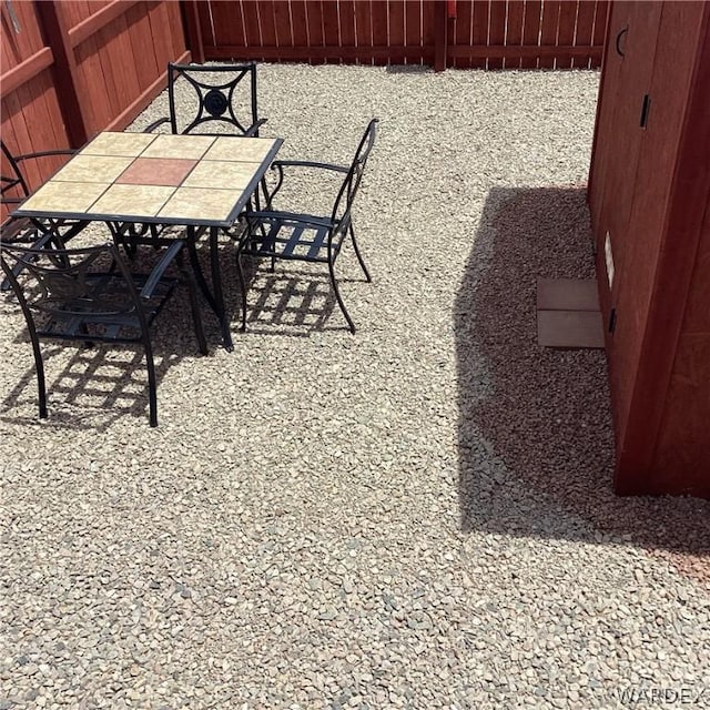 view of patio with fence and outdoor dining area