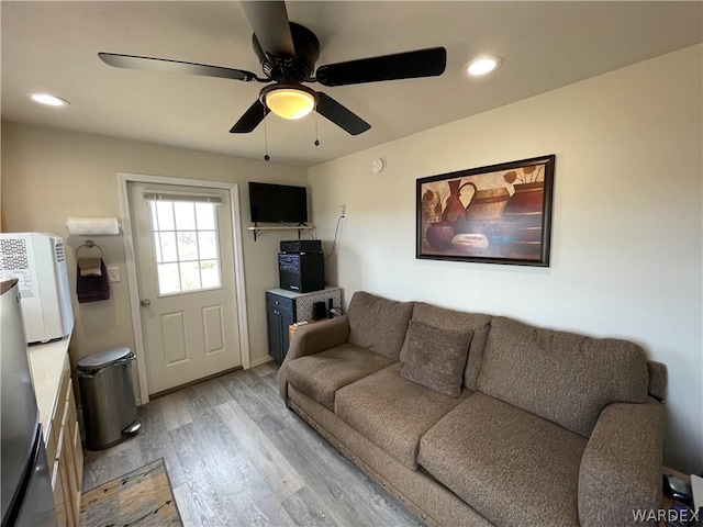 living room with light wood-style floors, recessed lighting, and a ceiling fan