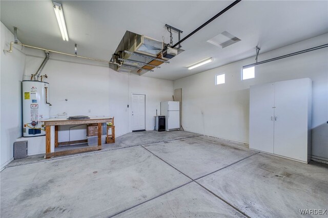 garage with water heater, a garage door opener, and freestanding refrigerator