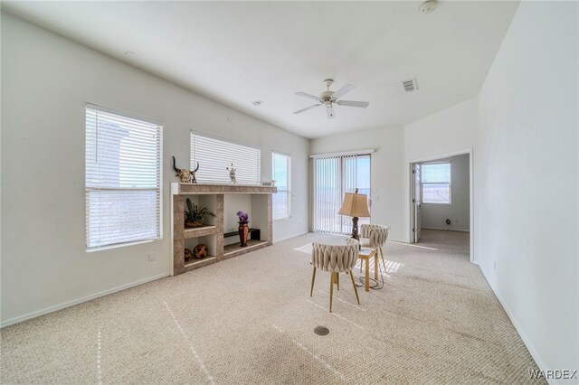 carpeted dining room featuring ceiling fan, visible vents, and baseboards