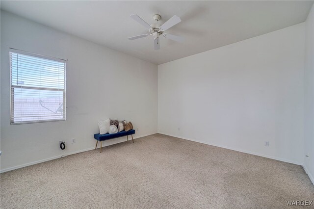 empty room featuring carpet and a ceiling fan