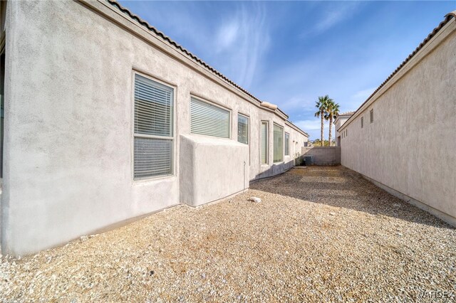 view of property exterior featuring a tile roof and stucco siding