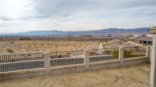 view of yard with fence and a mountain view