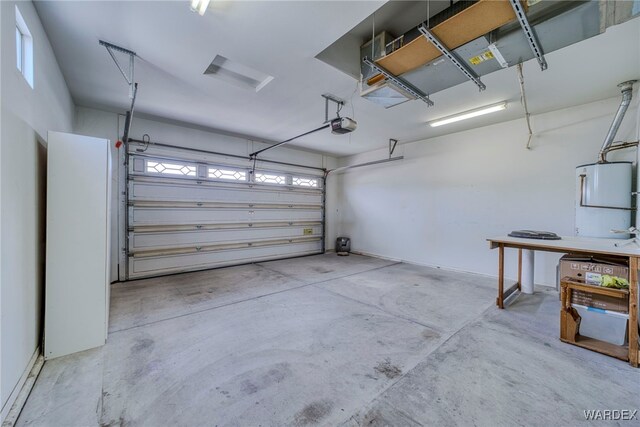 garage featuring a garage door opener and water heater