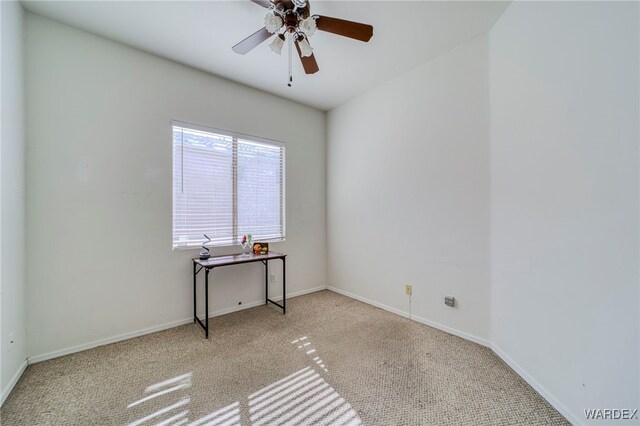 empty room with light carpet, ceiling fan, and baseboards