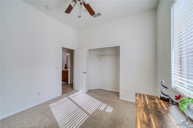 unfurnished bedroom with light carpet, baseboards, visible vents, and a closet