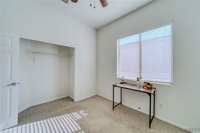 bedroom featuring a closet, light carpet, ceiling fan, and baseboards