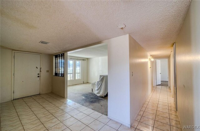 entrance foyer with visible vents and a textured ceiling