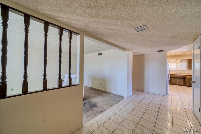 empty room with visible vents and a textured ceiling