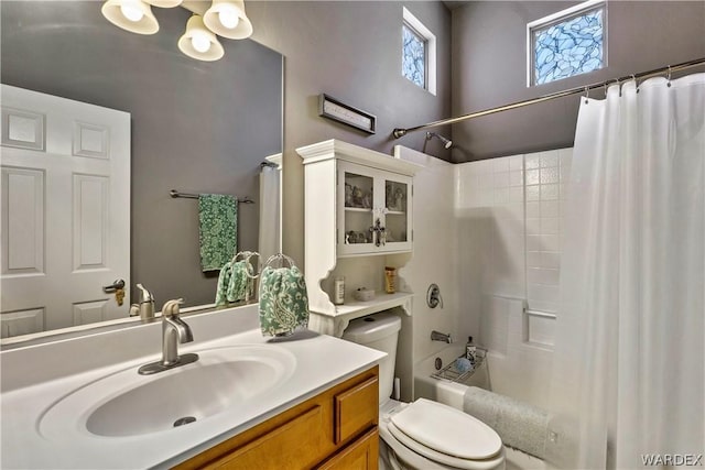 bathroom featuring toilet, vanity, and shower / tub combo with curtain