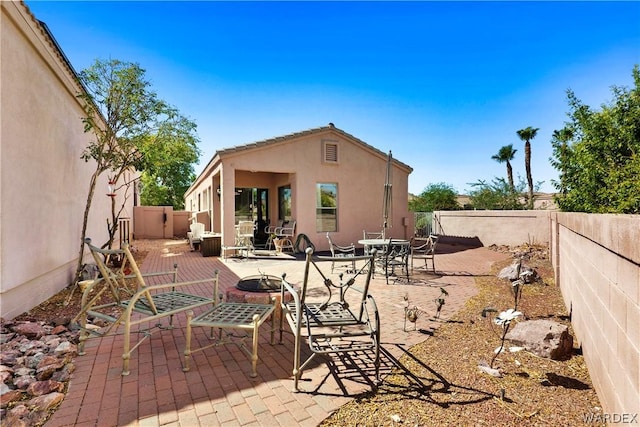 view of patio / terrace featuring an outdoor fire pit and a fenced backyard