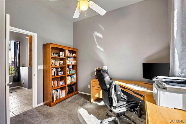 office space with carpet flooring, a ceiling fan, and baseboards