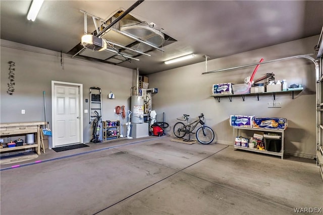 garage featuring water heater and a garage door opener