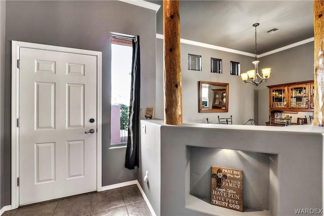 foyer with a chandelier, visible vents, crown molding, and baseboards