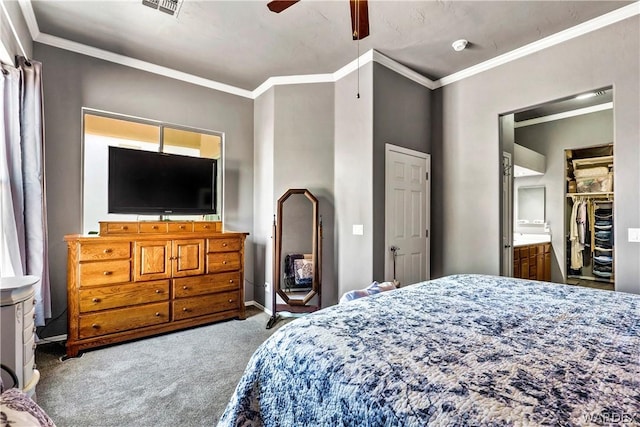 bedroom with crown molding, visible vents, a spacious closet, a ceiling fan, and carpet flooring