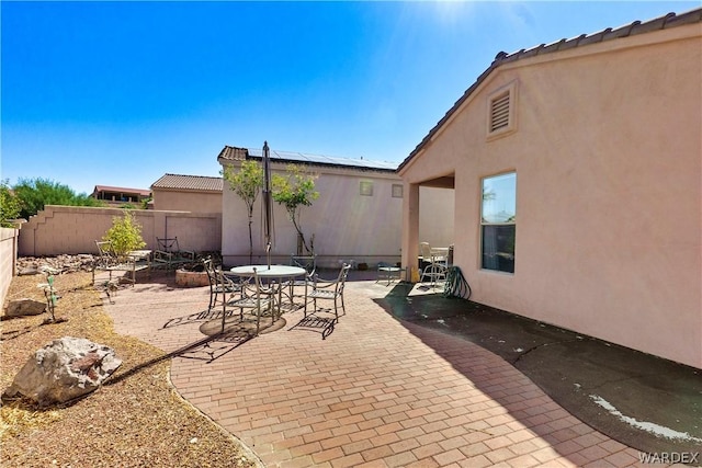 view of patio featuring a fenced backyard and outdoor dining area