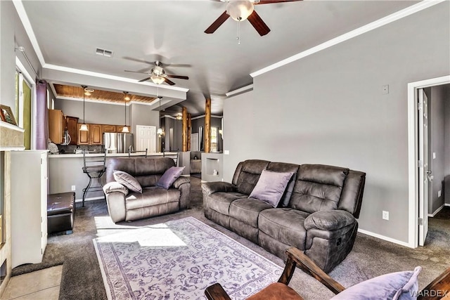 living room featuring ceiling fan, light carpet, visible vents, baseboards, and ornamental molding