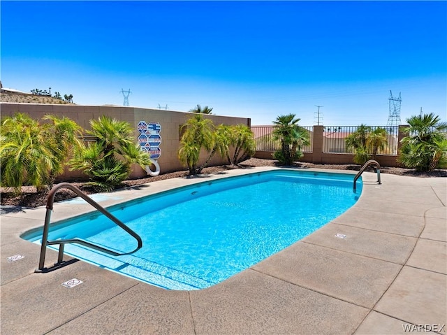 view of swimming pool featuring fence and a fenced in pool