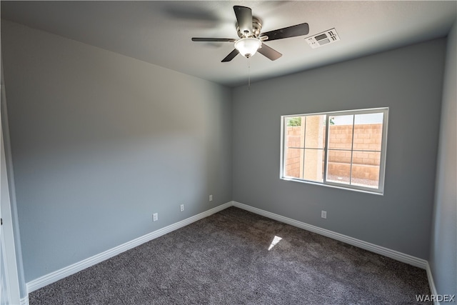 unfurnished room with a ceiling fan, dark colored carpet, visible vents, and baseboards