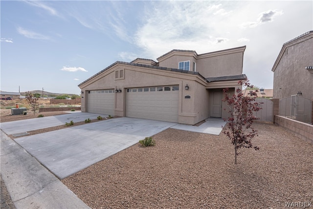 view of front of property featuring an attached garage, concrete driveway, and stucco siding