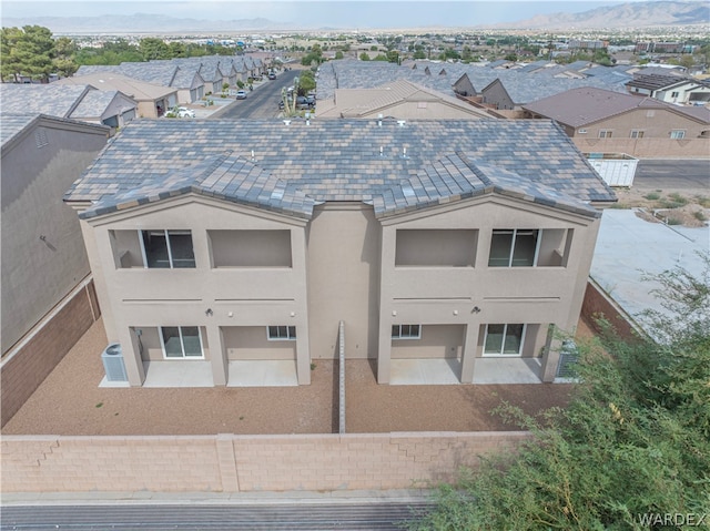 back of property featuring a patio area, a fenced backyard, a residential view, and stucco siding